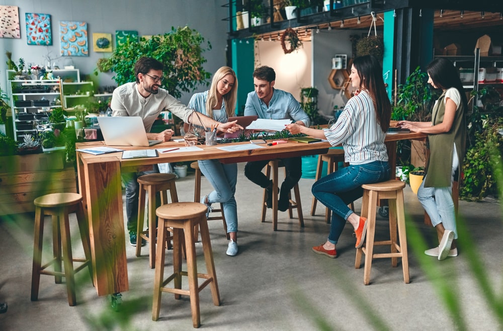 Young professionals gathered in a green office