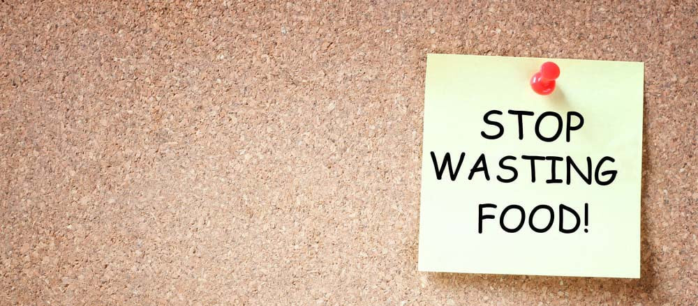 Stop wasting food written on note pad